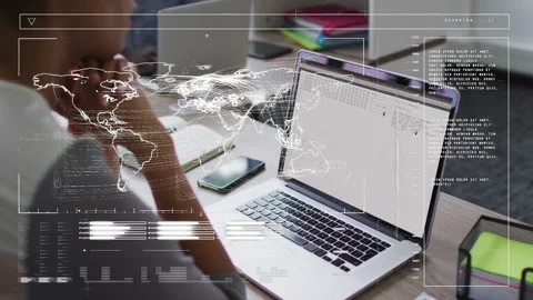 Data analyst resting chin watching laptop updating to table, HUD charts guiding Stock Footage 332955960