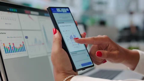 Data Analyst Reviewing Financial Dashboard On Laptop While Stock Footage 342969554