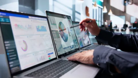 Data Analyst Reviewing Financial Dashboard On Laptop Stock Footage 343883588