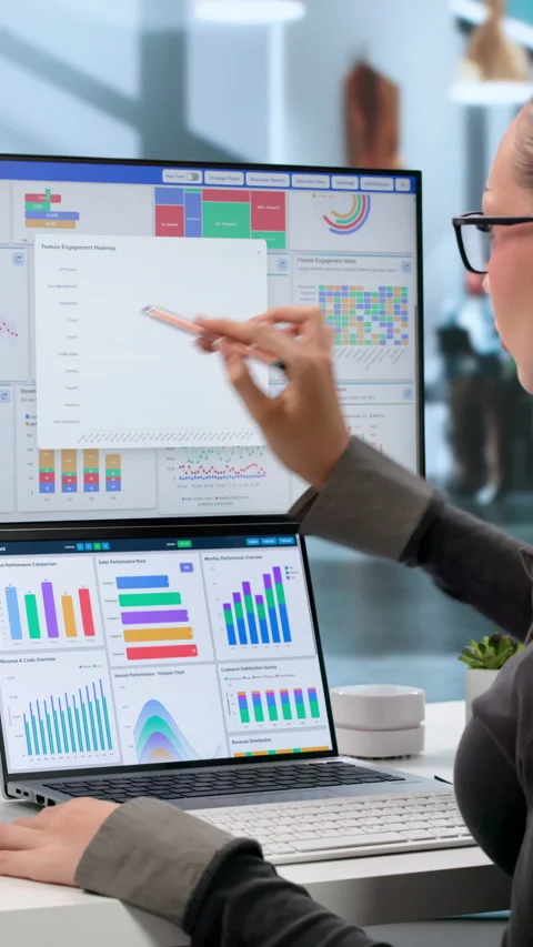 Data Analyst Reviewing Financial Dashboard 動画素材 345861287