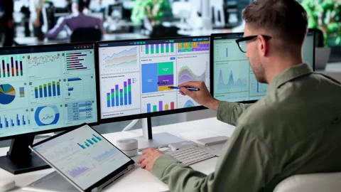 Data Analyst Reviews Financial Dashboard On Laptop Stock Footage 339888241