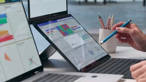 Data Analyst Reviews Financial Dashboard, Monitoring High KPIs Stock Footage 347905293