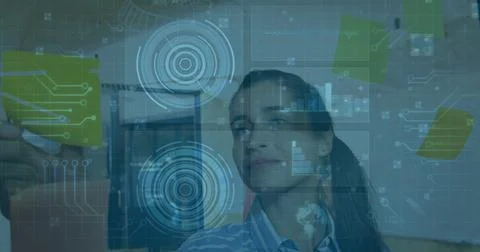 Data analyst in striped top combining sticky notes and digital charts in office, Stock Photos