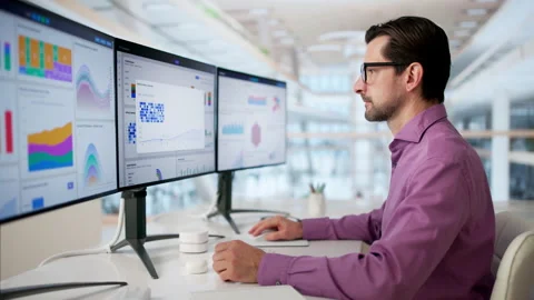 Data Analyst Studies Financial Charts Carefully Managing Corporate Performance Stock Footage 334929998