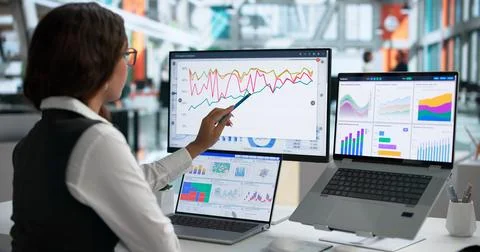 Data Analyst Studies Market Trends On Laptop, Planning Smart Business Moves. Stock Photos