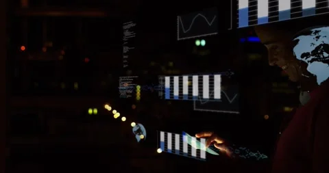 Data analyst tapping tablet in night office, aligning 3D charts with device and Stock Footage 321799939