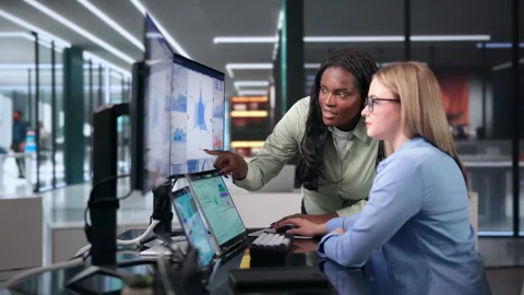 Data Analysts Collaborate In Office, Reviewing Dashboard KPIs Stock Footage 342980491