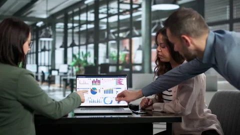 Data Analysts Collaborating In Office, Reviewing KPI Dashboard Stock Footage 347300894