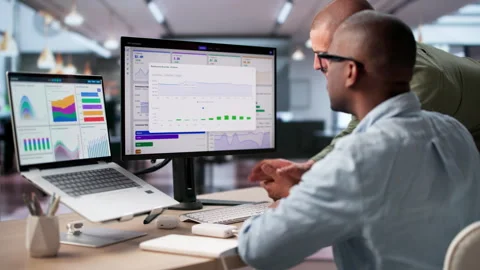 Data Analysts Discuss KPI Dashboard Stock Footage 335451584