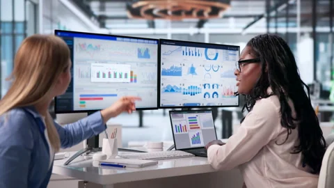 Data Analysts Discussing Key Financial Metrics Stock Footage 345322792