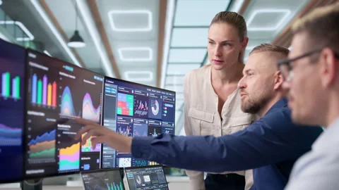 Data Analysts In Office Reviewing Financial Dashboards Stock Footage 338169271