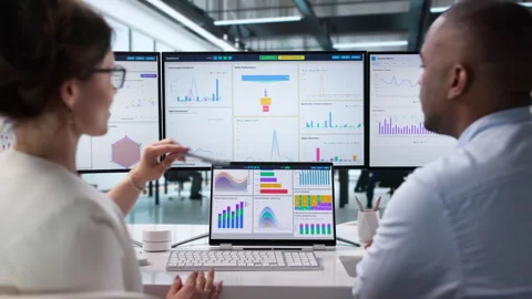 Data Analysts Review Financial Dashboards Together Stock Footage 341003457