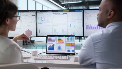 Data Analysts Review Financial Dashboards Together Stock Footage 342974589