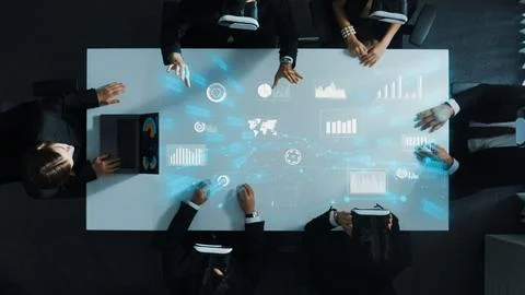 Data analysts wearing VR headset with hologram of finance graph. Directorate. Stock Photos
