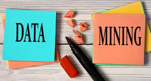 DATA and MINING - words on multi-colored sheets on a light wooden background Stock Photos