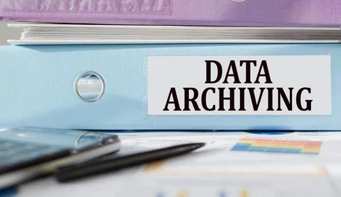 DATA ARCHIVING text written on folder with documents and calculator. Stockfoto's