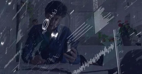 Data arriving, seated pro consulting phone and noting while analyzing charts Stock Photos