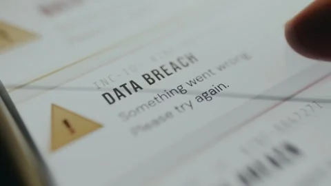 Data breach alert displayed with yellow triangle warning indicator Stock Footage 334931429