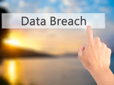 Data Breach - Hand pressing a button on blurred background concept on visual  Stock Photos