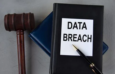 DATA BREACH - word on a white sheet with leather notebooks, a judge's hamme.. Foto stock