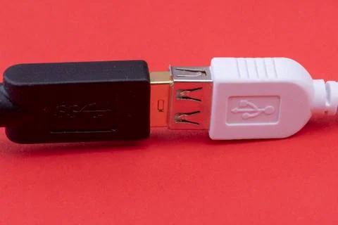 Data cable extension plug white and black cable together on red background Stock Photos