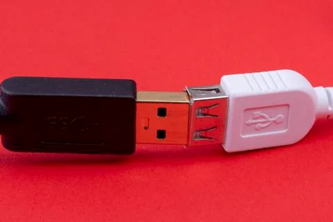 Data cable extension plug white and black cable together on red background Stock Photos