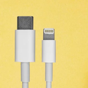 Data cable lugs for a smartphone on a yellow background, a mockup of an adver Stock Photos