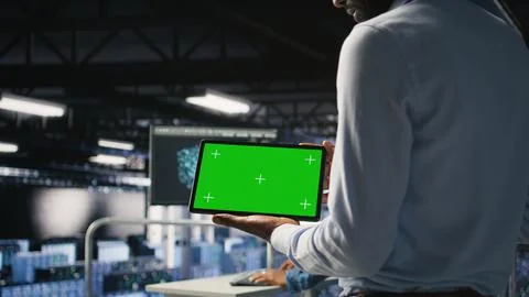 Data center admin checking code on tablet next to colleague Stock Photos