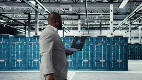 Data center admin doing IT maintenance tasks using AI technology Stock Footage 311897960