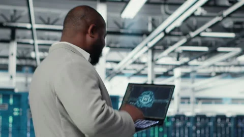 Data center admin doing IT maintenance tasks using AI technology Stock Footage 311959441