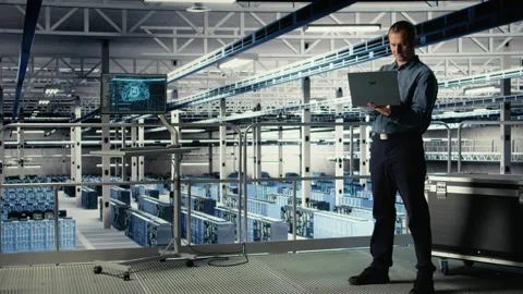 Data center admin on industrial platform checks AI dashboard using laptop Video stock 314805668