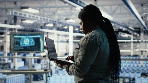 Data center admin investigates AI configurations using laptop Stock Footage 314686385