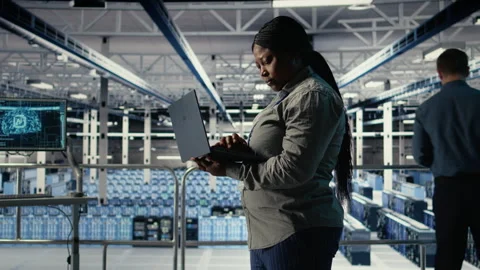 Data center admin investigates AI configurations using laptop Stock Footage 314804897