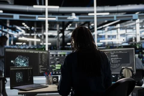 Data center admin looks at AI visualization dashboard on laptop Stock Photos