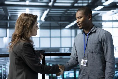 Data center admin meeting with supervisor verifying workspace security Stock-Fotos