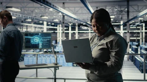 Data center admin monitors deep learning process with laptop Stock Footage 314684614