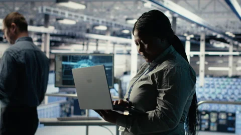 Data center admin monitors deep learning process with laptop Stock Footage 314804251