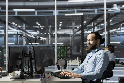 Data center admin running diagnostic scripts on PC, examining infrastructure Stock Photos