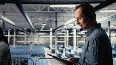 Data center admin talking in audio headset mic, helping clients Stock Footage 314683149