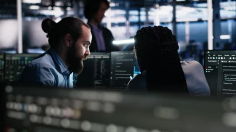 Data center admin teaching intern to monitor neural network using AI Stock Footage 313635985