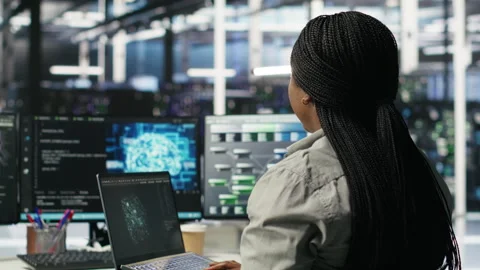 Data center admin uses AI technology on laptop for machine learning workloads Stock Footage 307333018