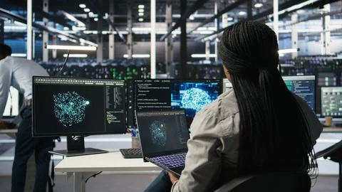 Data center admin uses AI technology on laptop for machine learning workloads Stock Photos
