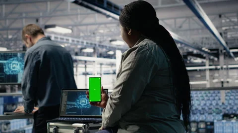 Data center admin uses isolated screen smartphone while deploying deep learning Stock Footage 314804592