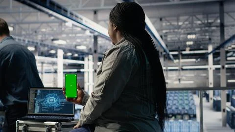 Data center admin uses isolated screen smartphone while deploying deep learning Foto stock