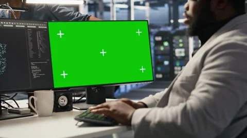 Data center admin using isolated screen PC to monitor neural network AI Stock Footage 309620345