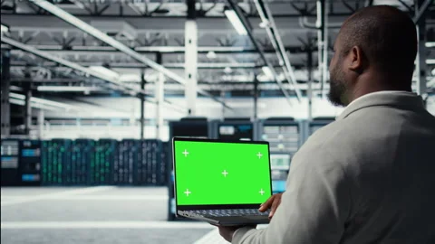 Data center admin using isolated screen laptop to monitor neural network AI Stock Footage 311959224