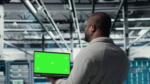 Data center admin using isolated screen laptop to monitor neural network AI Stock Footage 311959886
