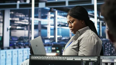 Data center admin using laptop to do node tree programming Stock Footage 309123004