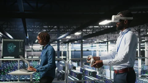 Data center admin using VR headset to monitor neural network AI systems Stock Footage 310278825