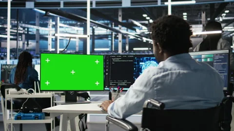 Data center admin in wheelchair using AI node tree software on green screen PC 스톡 동영상 307038723